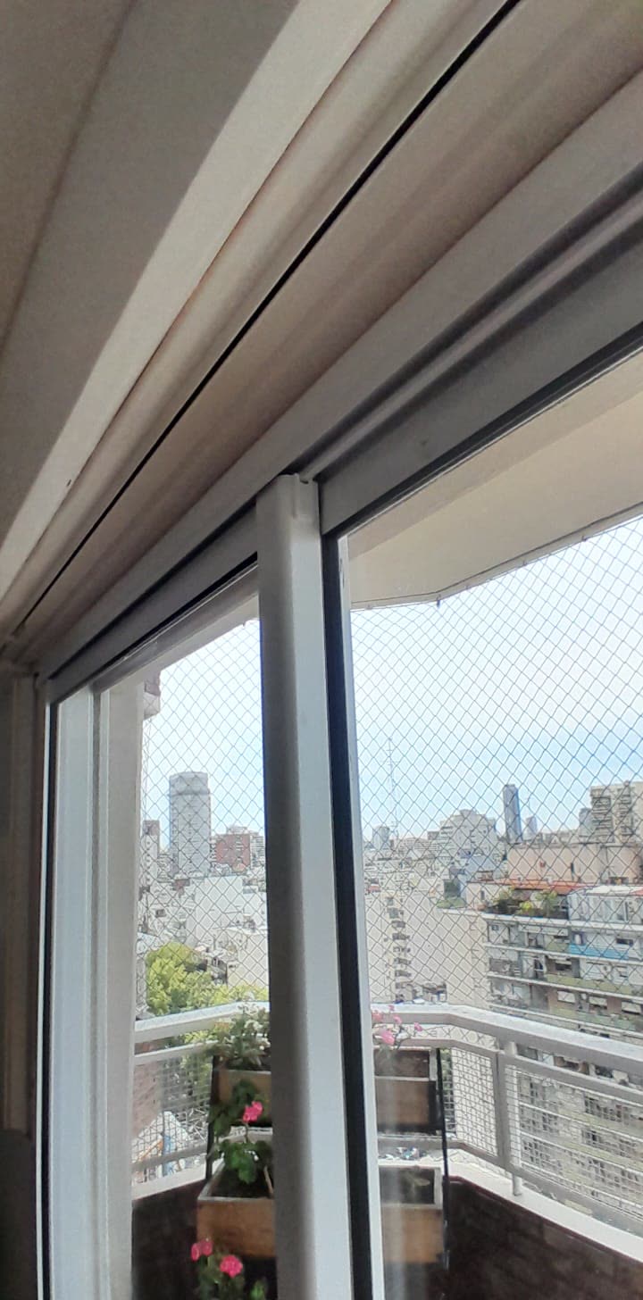 Corrediza con vista a la ciudad desde un balcón en altura